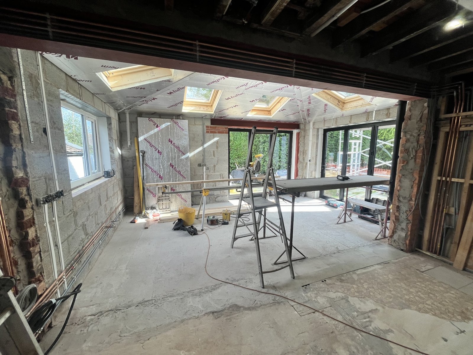 The extension as a shell, steel in place and the back of the house opened up